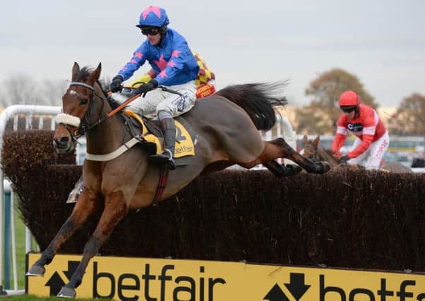 Cue Card and Joe Tizzard on their way to victory in the Betfair Chase during the Betfair Chase Festival at Haydock Park Racecourse, Newton-le-Willows.