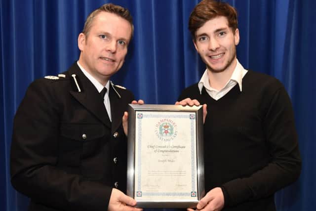 Joseph Miles is presented with his award by Acting Chief Constable Graham McNulty