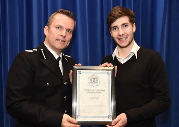 Joseph Miles is presented with his award by Acting Chief Constable Graham McNulty