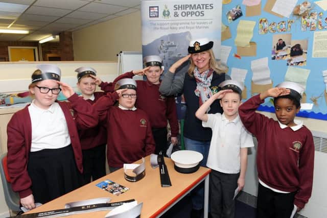 (L-r) Elouise Knight (10), Jacques Langan (9), Jamie Bryson (8), Coby Fleetwood (8), Chrissie Hughes from the Royal Naval Association, Finley Harris (7) and Zantay Campbell (8)