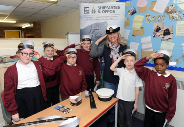 (L-r) Elouise Knight (10), Jacques Langan (9), Jamie Bryson (8), Coby Fleetwood (8), Chrissie Hughes from the Royal Naval Association, Finley Harris (7) and Zantay Campbell (8)
