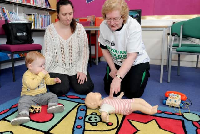 St John Ambulance trainer Beverley Stotesbury (right) teaching Natalie Collins and her son Robert-Paul Shaw about how to give CPR to babies   Picture: Sarah Standing (160456-4978)