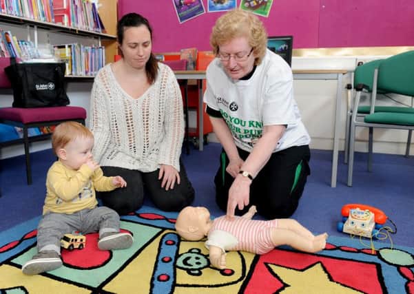 St John Ambulance trainer Beverley Stotesbury (right) teaching Natalie Collins and her son Robert-Paul Shaw about how to give CPR to babies   Picture: Sarah Standing (160456-4978)