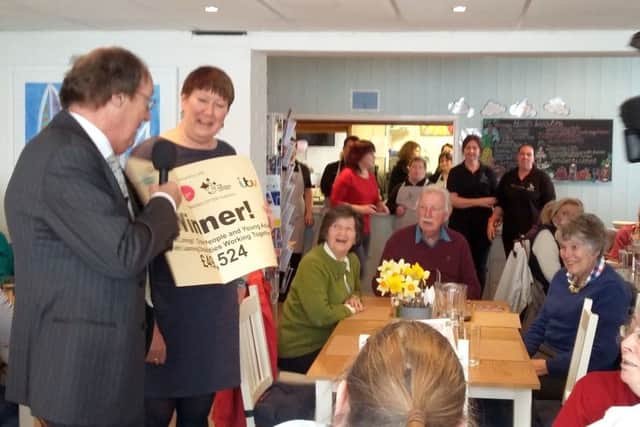 Wendy Shone from Silver Linings being presented with the cheque by Fred Dinenage from ITV Meridian News