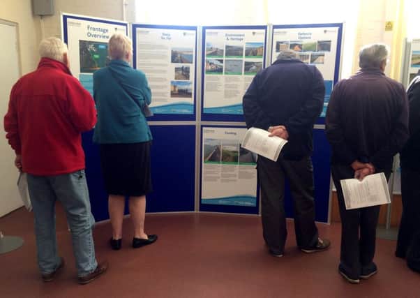 People looking at the display on flood defences  Picture: Olivia Meades
