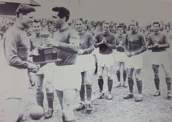 Jimmy Dickinson is presented with a trophy by Harry Harris after his last game at Fratton Park