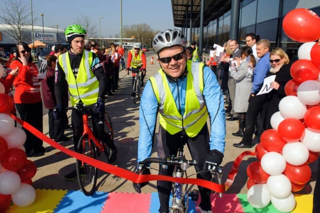 Darren Noonan crosses the finishing line at Sainsbury's in Waterlooville to complete his Sport Relief cycle challenge