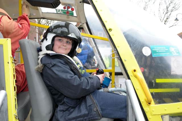 Mason Brown, 10, takes a seat in the cockpit of the Hampshire Air Ambulance