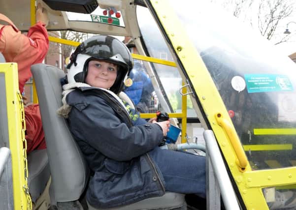 Mason Brown, 10, takes a seat in the cockpit of the Hampshire Air Ambulance