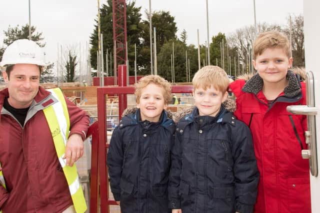 Crane driver Luke Bennett with eight year old George Osborne (right) and his six year old twin brothers Oscar and Oliver.Picture: Trevor Warr Photography
