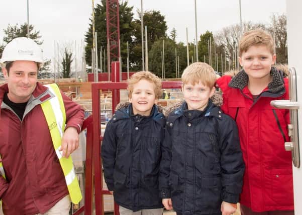 Crane driver Luke Bennett with eight year old George Osborne (right) and his six year old twin brothers Oscar and Oliver.
Picture: Trevor Warr Photography