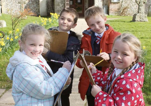 WORKSHOPS Alfie Vincent and Harrison Clarkson, both aged eight, and Chloe Thomas and Olivia Wilds, both seven, all from Horndean C of E Junior School, explore the churchyard at All Saints Church, Catherington