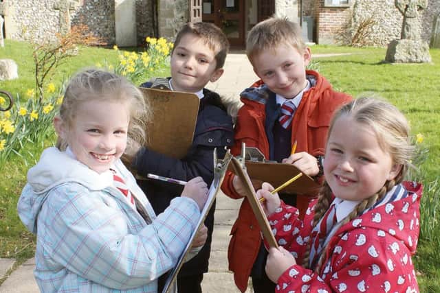 WORKSHOPS Alfie Vincent and Harrison Clarkson, both aged eight, and Chloe Thomas and Olivia Wilds, both seven, all from Horndean C of E Junior School, explore the churchyard at All Saints Church, Catherington