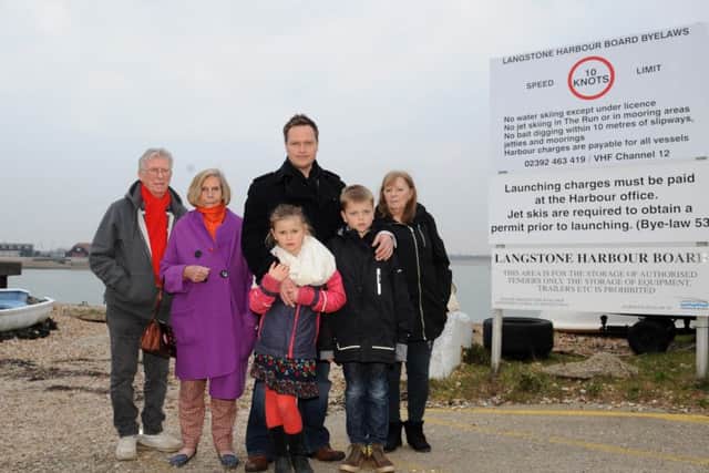 Mark Coates is campaigning to clean up Langstone Harbour. He is pictured with his two children Livvy, six, Joe, nine, and other Hayling Island residents who are backing the online petition, from left, Jack Mealy, 74, Pauline Scutt, 80, and Sheila Mealy, 72
Picture: Sarah Standing (160537-9180)