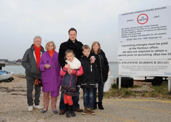 Mark Coates is campaigning to clean up Langstone Harbour. He is pictured with his two children Livvy, six, Joe, nine, and other Hayling Island residents who are backing the online petition, from left, Jack Mealy, 74, Pauline Scutt, 80, and Sheila Mealy, 72
Picture: Sarah Standing (160537-9180)