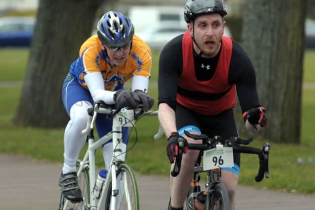 Bryan Puszkar, number 96, is chased by Graeme Oliver in the Portsmouth Duathlon