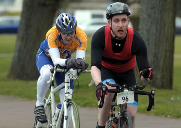 Bryan Puszkar, number 96, is chased by Graeme Oliver in the Portsmouth Duathlon