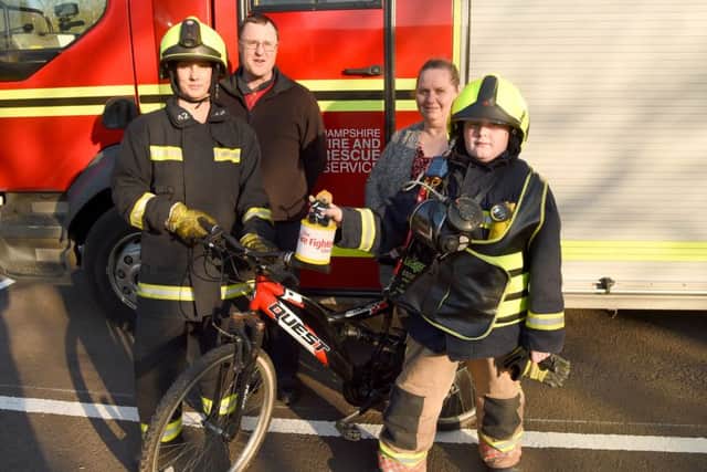 Andrew Impey at Hamphire Fire and Rescue headquarters with firefighter Julie Jacobs and his parents
