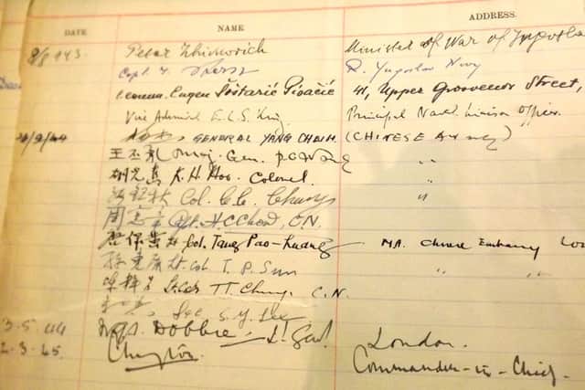 A page from the wardroom guest book with signatures of the Chinese Army personnel.