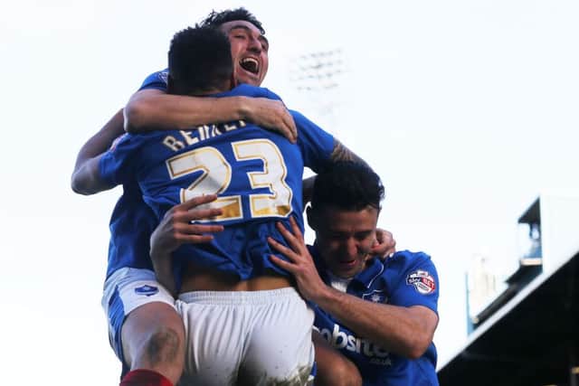 Kyle Bennett, Gary Roberts and Enda Stevens celebrate during the 4-0 win over Notts County on Good Friday Picture: Joe Pepler