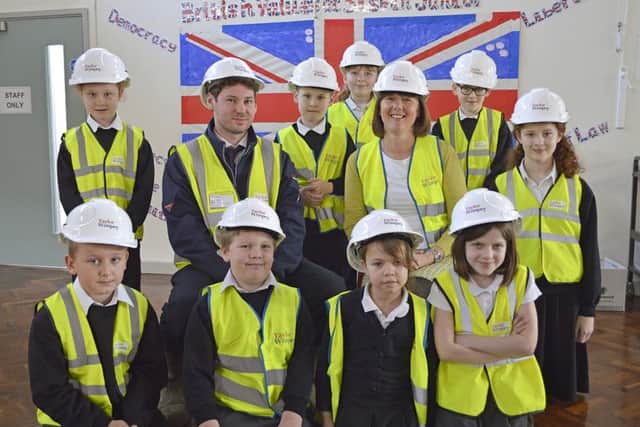 Paul Cooper of Taylor Wimpey, centre left, and Amanda Wray of Siskin Junior School, right) with pupils Picture: Taylor Wimpey