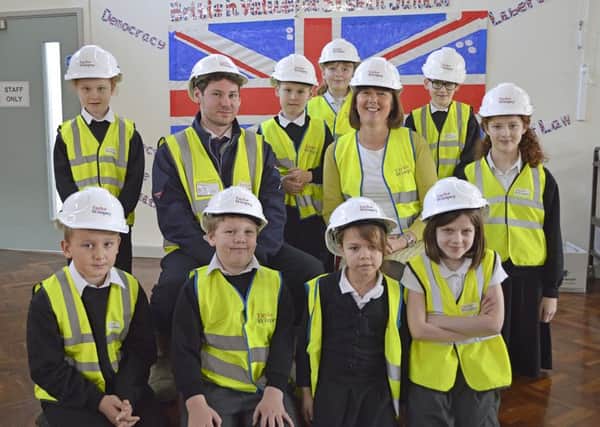 Paul Cooper of Taylor Wimpey, centre left, and Amanda Wray of Siskin Junior School, right) with pupils Picture: Taylor Wimpey