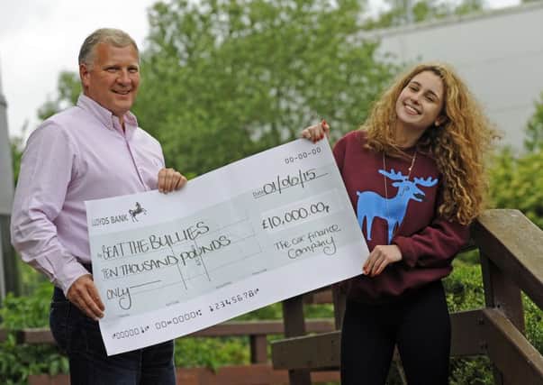 Chloe Hine from Beat the Bullies with Mark Smith from The Car Finance Company and her Â£10,000 cheque