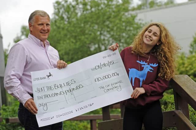 Chloe Hine from Beat the Bullies with Mark Smith from The Car Finance Company and her £10,000 cheque