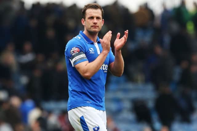 Pompey skipper Michael Doyle applauds the fans at the final whistle Picture: Joe Pepler