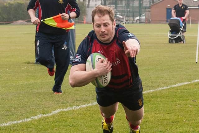 Luke Peters crosses the line for United Services. Picture: Keith Woodland