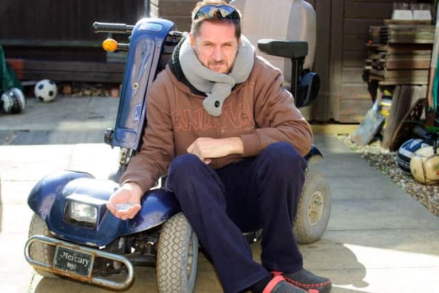 Nick Rundle pictured with his mobility scooter that was attacked and broken by a boy