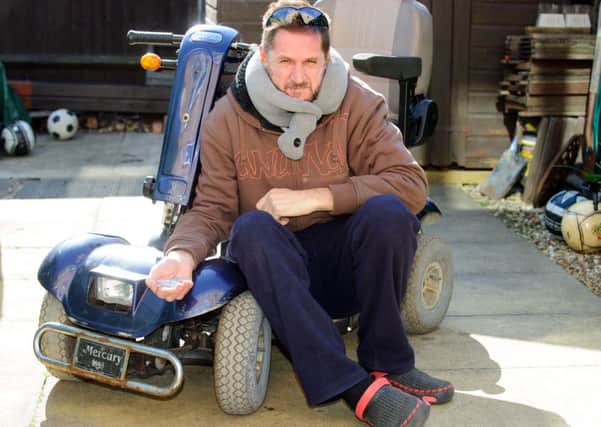 Nick Rundle pictured with his mobility scooter that was attacked and broken by a boy