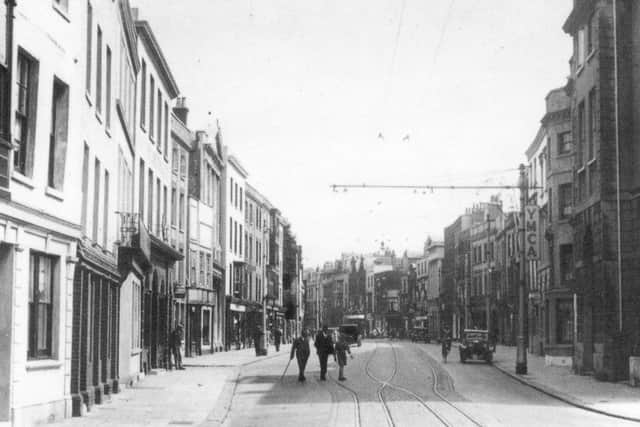 VILLAGE PEOPLE Old Portsmouth today often has the feel of a small, rural community. In this pre-war picture of High Street, long before the Luftwaffe did its worst, it looks like a city, with the YMCA building on the right