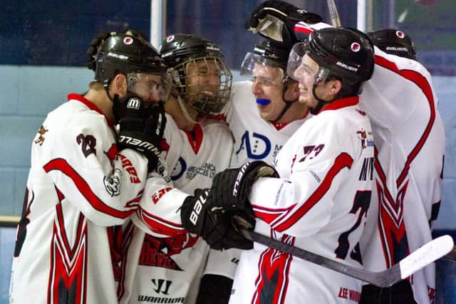 Devils celebrate scoring against Raiders