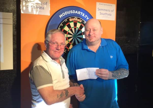 PDC player Rob Modra, right, picks up his Paulsgrove Open winnings from Pete Heather