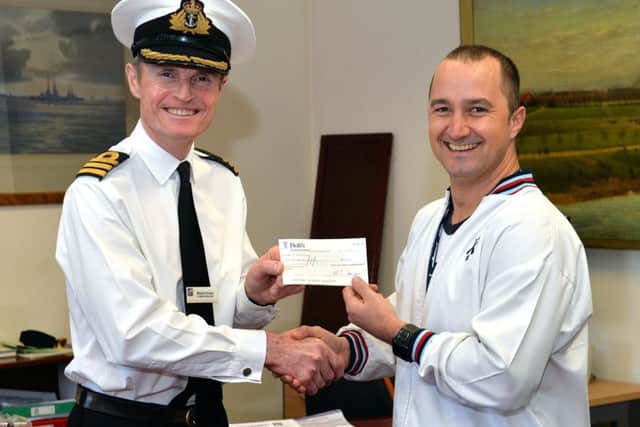 Keith McCormick, right, receives his award from Commanding Officer Martin Evans   Picture: Ken Gaunt