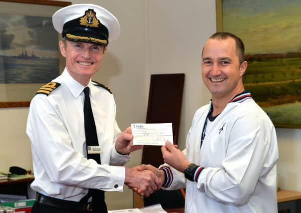 Keith McCormick, right, receives his award from Commanding Officer Martin Evans   Picture: Ken Gaunt