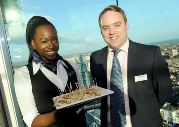 Waitress Penelope Kyakulagira, 20, from Southsea, with Oli Cullingworth, the group food and beverage manager for Continuum, which operates the Spinnaker Tower 

Picture: Sarah Standing (160570-716)