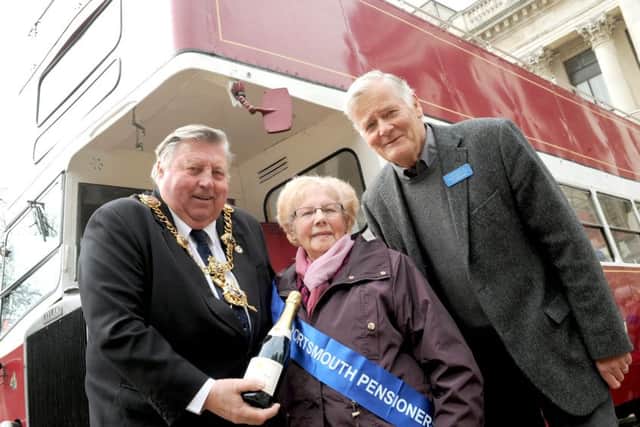 Lord Mayor of Portsmouth Frank Jonas presenting bus pass holder Nell Leaver with a bottle of champagne and Alan Burnett, chairman of the Portsmouth Pensioners' Association Picture: Sarah Standing (160566-195)