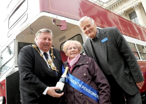 Lord Mayor of Portsmouth Frank Jonas presenting bus pass holder Nell Leaver with a bottle of champagne and Alan Burnett, chairman of the Portsmouth Pensioners' Association 

Picture: Sarah Standing (160566-195)