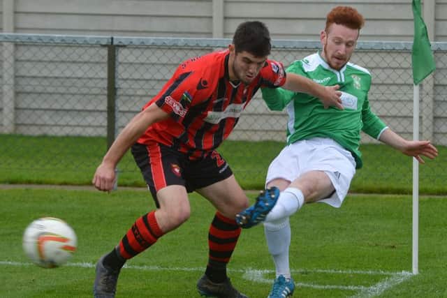 Aylesbury Utd v Petersfield Town. Billy Adcock, Utd, gets a cross in past Petersfield's Lewis Hyde in the reverse fixture. Picture: Jake McNulty