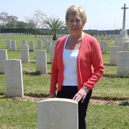 Rivka Cresswell at the grave of Ronald Carpenter in Israel
