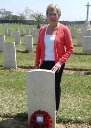 Rivka Cresswell at the grave of Ronald Carpenter in Israel