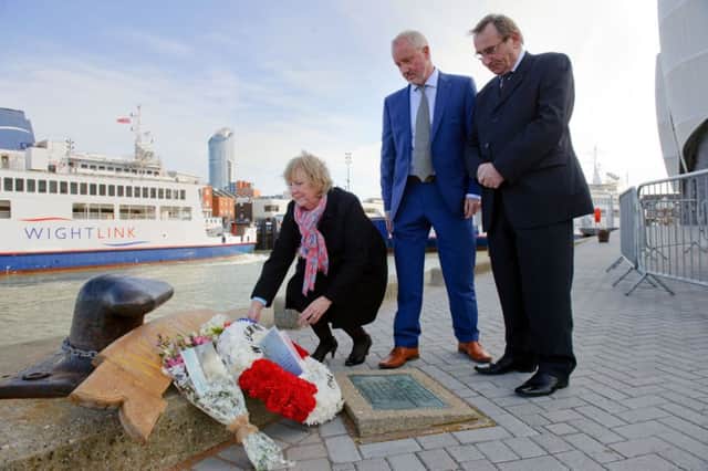 From left, Cheryl Gray, Andrew Johnson and Bob Gray, place flowers on the plaque remembering those who died aboard the Wilhelmina J, which sank 25 years ago Picture: Allan Hutchings (060511-984)
