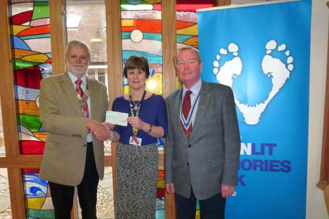 FORCE FOR GOOD Gosport Rotary president Ken Eckersley and Rotary secretary Graham Collins present a cheque to Lesley Clayton at Rowans
Pictures: Malcolm Dent