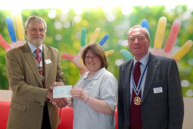 Gosport Rotary president Ken Eckersley and Rotary secretary Graham Collins present a cheques to Sarah Hudson at Naomi House