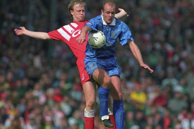 Colin Clarke is put under pressure by Mark Wright during the FA Cup semi-final against Liverppol at Highbury in 1992