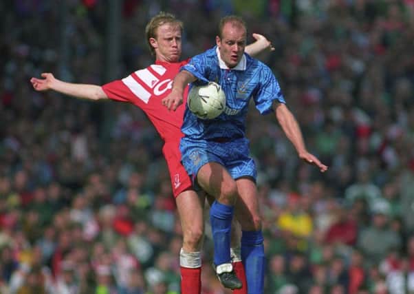 Colin Clarke is put under pressure by Mark Wright during the FA Cup semi-final against Liverppol at Highbury in 1992