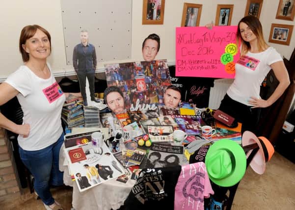 Vicky Hall, 29, and her mum Karen Hall, 54, from Gosport, with just some of their Take That merchandise.  

Picture: Sarah Standing (160604-1262)