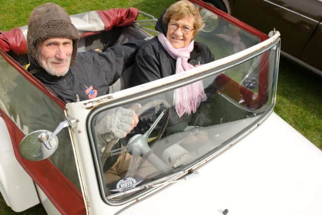 Mike Hele and his wife Renate and their Bond Mini car MkD family model from 1957
